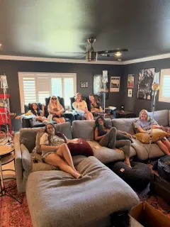 A group relaxing on sofas and recliners during IV therapy at home.
