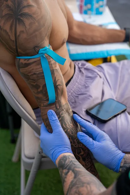 A clinician placing an IV line in a client's arm.
